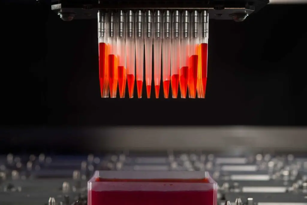 closeup of red pipetting system with red fluid
